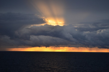 Amazing sunset with long rays piercing the clouds