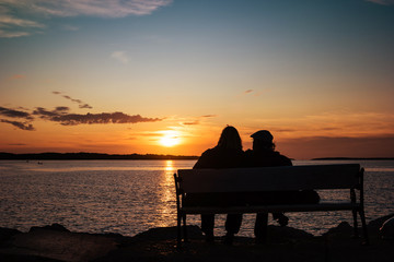 Obraz na płótnie Canvas Happy mature couple silhouette at sunset in Fazana, Croatia