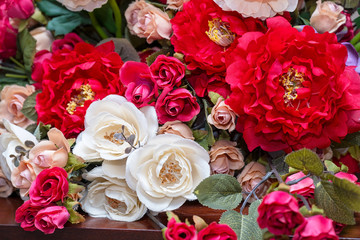 Bouquet of artificial red and white roses close-up. Selective focus