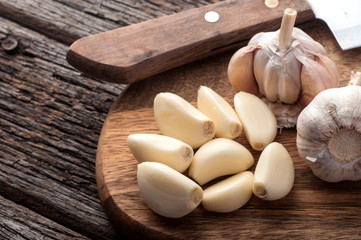 Sliced Garlic and garlic bulb on vintage wooden background. Place for text, copy space. Concept of healthy food.