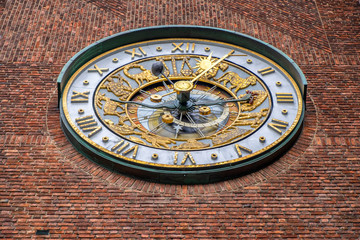 Fototapeta na wymiar Oslo, Norway - Facade of City Hall historic building - Radhuset – with astronomic tower clock in Pipervika quarter of city center