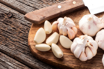 Sliced Garlic and garlic bulb on vintage wooden background. Place for text, copy space. Concept of healthy food.