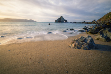 Calm Silky Waves Caress the Golden Sand of a Beach