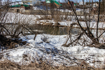Fototapeta na wymiar Winter rural river snowy landscape. Forest river in winter snow.