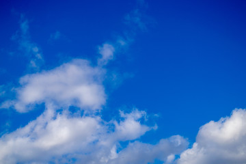 Bright white clouds on blue sky. Spring sunny day. Beautiful nature background.