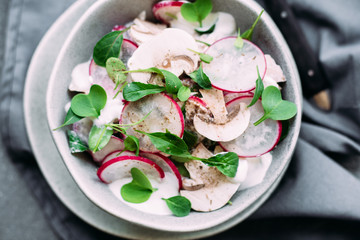 Salad with fresh mushrooms, radish and arugula. Vegetarian food. Lean salad