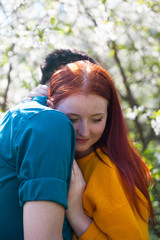 Fototapeta premium Young couple walking in spring garden.