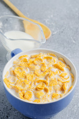 Corn flakes in milk. Blue Cup. Healthy and nutritious Breakfast. Copy space.
