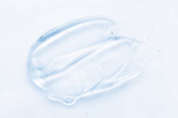 Transparent liquid gel cream smudge on white background