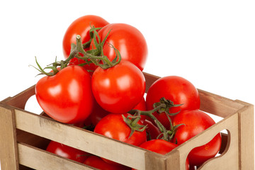 fresh tomatoes in a wooden crate isolate on a white background