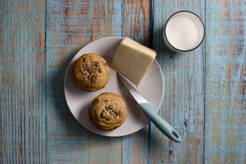 Corn bread made in the form of muffins ( proja ) with sesame and pumpkin seeds with cheese and glass of yogurt. Balkan cuisine. Blue rustic wooden background - Top View