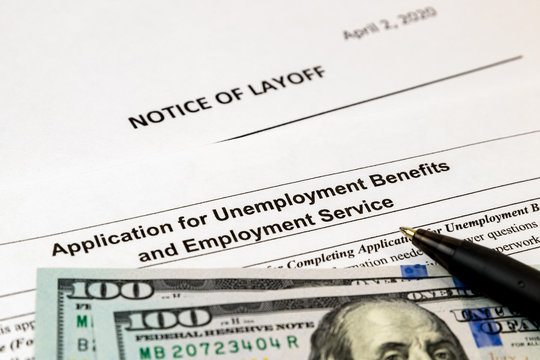 Job layoff notice and application for unemployment insurance benefits paperwork. Concept of Covid-19 coronavirus and stay at home order impact on economy