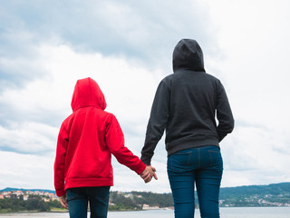 boy and girl outdoors holding hands, hope and future concept