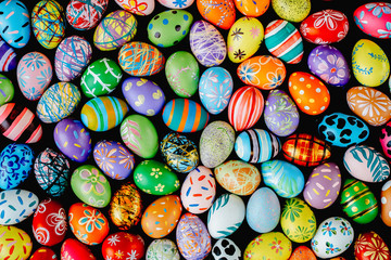 Fototapeta na wymiar Mixed many colorful easter eggs on ground. Abstract background. Holidays backdrop.