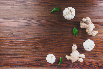 ginger garlic green leaves on wooden background