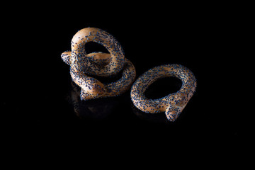 Bagels with poppy seeds on a dark background. Photographed close-up.