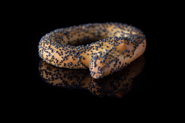 Bagels with poppy seeds on a dark background. Photographed close-up.