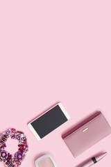  Leather wallet,  bracelet, lipstick and new smartphone on bright rose background.