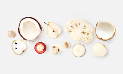 Creative layout made of mangosteen, coconut, cauliflower, cherimoya, pear, champignon, rambutan, cassava  on the white background. Flat lay. Food concept. Macro  concept.