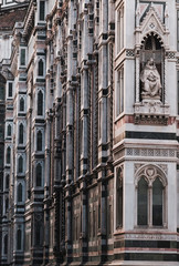 Santa Maria del Fiore Cathedral, beautiful detailed view of facade and statues, Florence, Tuscany, Italy. Piece of art, and part of Unesco. Structure and marble walls. Vertical amazing shot.