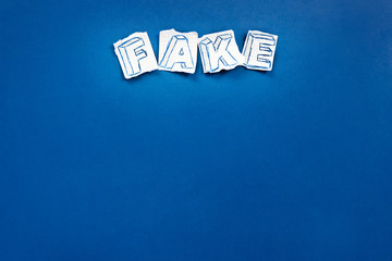 Paper art banner on blue backdrop in style zine wiht words fake news.