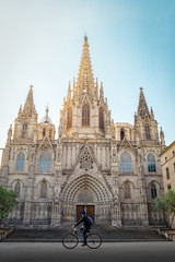 Fototapeta na wymiar Gothic cathedral of Barcelona with a cyclist