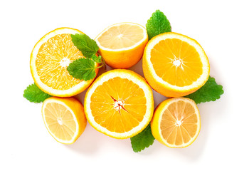 Halves of lemons and oranges on a white background, top view. Citruses and mint leaves for making lemonade.