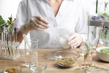 Obraz na płótnie Canvas Scientist developing cosmetic product in laboratory, closeup
