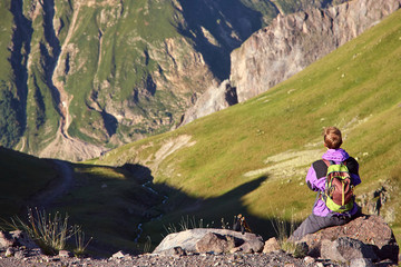 Fototapeta premium climber on trail in the mountains. a man with a backpack in a hike.