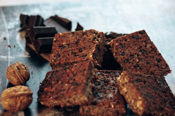 Homemade chocolate brownies or chocolate cakes with nuts on abstract background