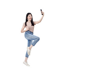 Fototapeta na wymiar Cheerful woman jumping holding smartphone