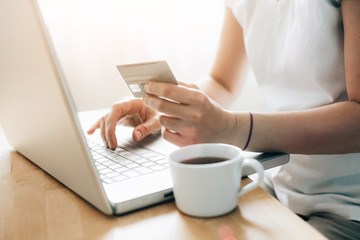 Hand holding credit card and and makes online shopping