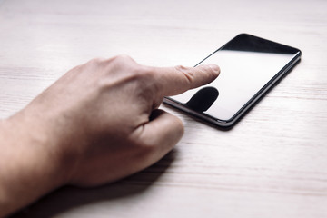 finger touching the screen of a smart phone