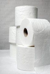 White rolls of toilet paper with white background