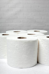 White rolls of toilet paper with white background