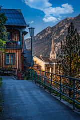 Narrow sidewalk above the downtown of Hallstatt, Austria with a view of the surrounding mountains.