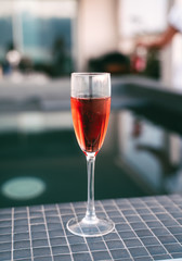 Classy rose wine glass and bottle on poolside