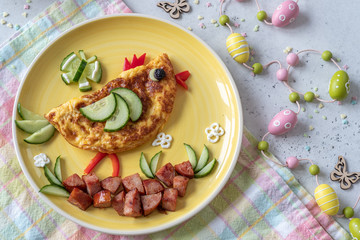 Funny chick egg omelette with ham vegetables for kids breakfast