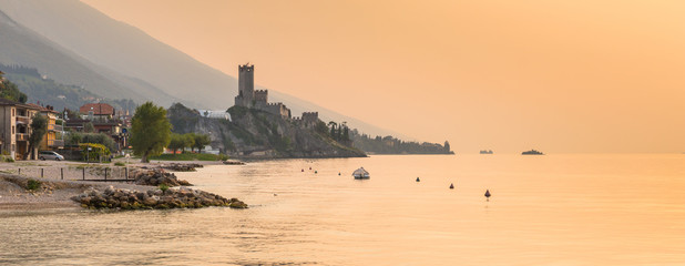 Scaliger Castle in Malcesine over the Garda lake at sunset, Italy - obrazy, fototapety, plakaty