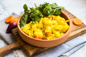 Vegetables stew with potato, carrot, cabbage and green spinach. Vegan food