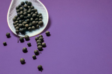 Black pepper on a violet background