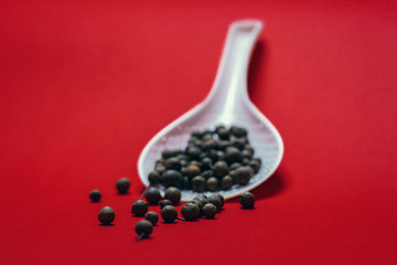 Black pepper on a red background