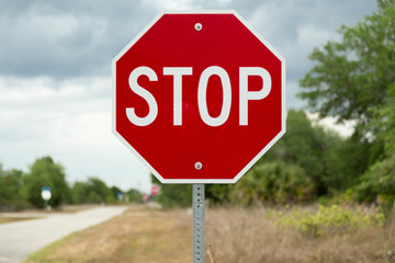 Stop sign on a road (USA/North American road sign)