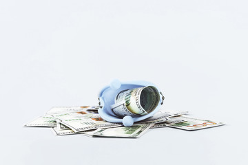 Open coins purse with hundred dollars notes on blue. Finance markets investments loans earnings concept. Personal accounting debts and credits or savings. bankruptcy with copy space