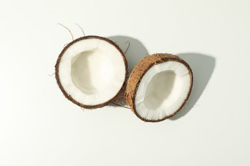 Halves of coconut on white background, top view
