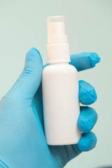 Bottle of antiseptic in hand Antibacterial spray for hands antiseptic. Hand antiseptic disinfection. Plastic bottle with clear body.