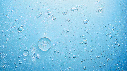 oil with bubbles on on dark blue background. Abstract background.