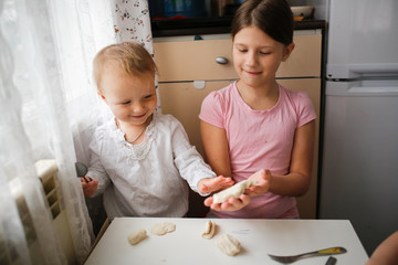 Children make the dough. Daughters help mom