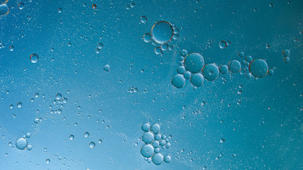 oil with bubbles on on dark blue background. Abstract background.