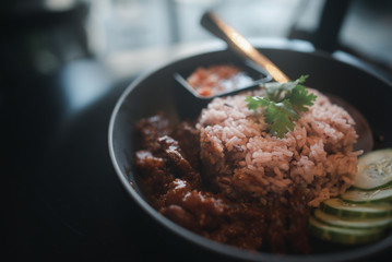 Brown rice served with special meat stew, delicious aroma, cucumber, coriander and tasty chili paste in the cafe, business ideas, and restaurant menus Inspiration of the new generation
